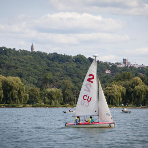 Students sail on Cayuga Lake in summer.