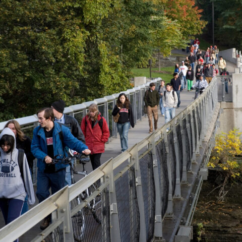 Students cross the suspension bridge.