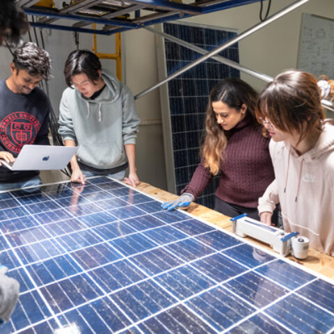 Members of the Cornell University Sustainable Design from left to right, Anant Gupta, Saikant Gamble, En Lo, Sarah Alruwaily, and Michelle Yang work on their refurbished solar panels.