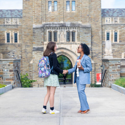 Move-In Day 2023. Two people shake hands.