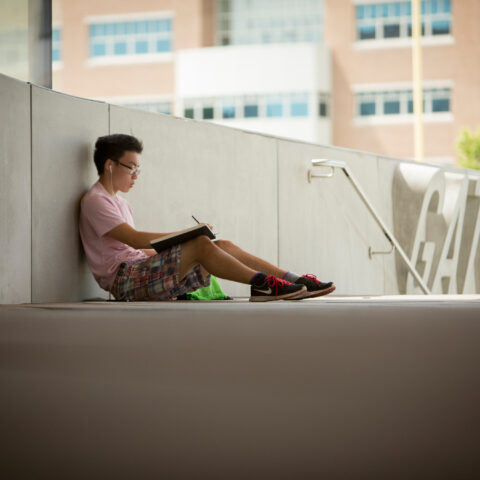 Summer Session (CESS) students on campus. A student studies outside Gates Hall.