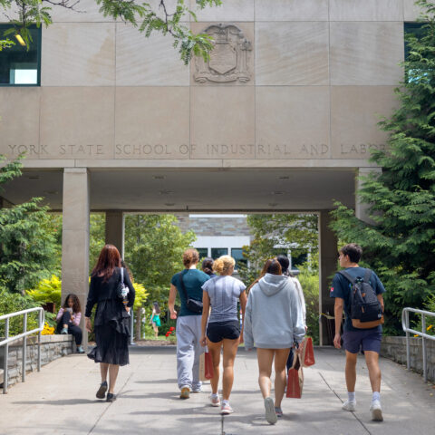 Students walk towards the Ives courtyard at the ILR School