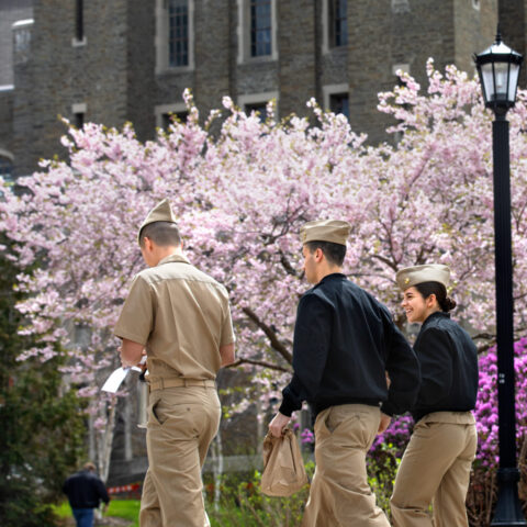 ROTC cadets pass by cherry trees on their way to Barton Hall